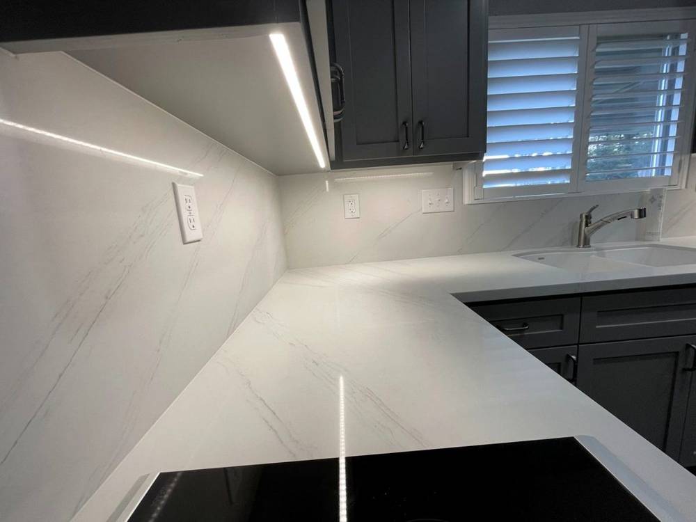Gray shaker, white quartz, under-cabinet lighting