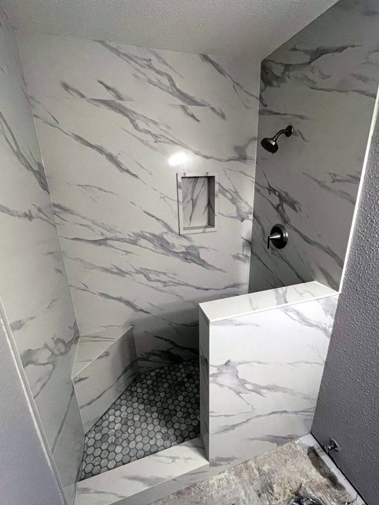 Marble shower with a bench